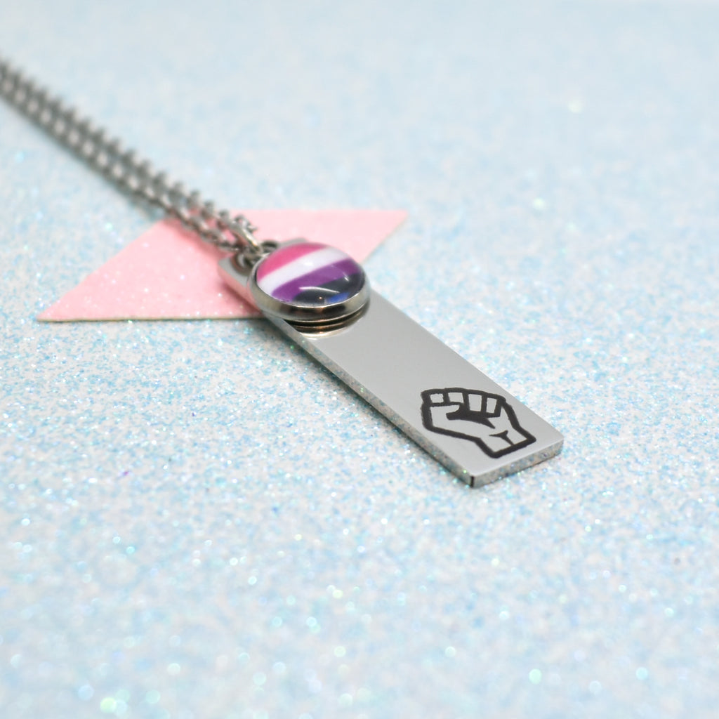 a silver necklace with a purple and black fist print on it